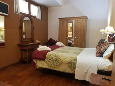 a bedroom with a bed and a mirror at Aurelia Garden Gold B&B in Rome