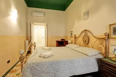 a bedroom with a bed with two towels on it at Roman Apartment in Rome