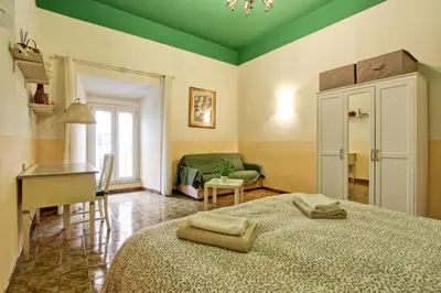 a bedroom with a bed and a table and a couch at Roman Apartment in Rome