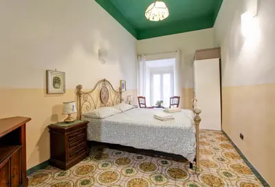 a bedroom with a bed and a table and chairs at Roman Apartment in Rome