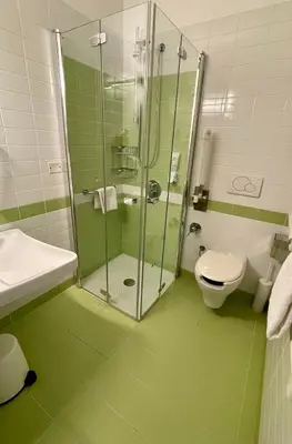 a bathroom with a glass shower and a toilet at Domus Helena in Rome