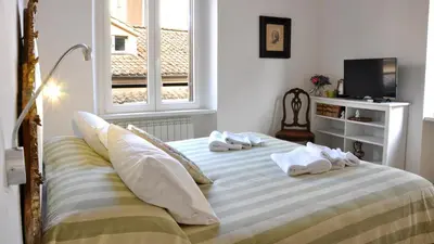 a bedroom with a bed with towels on it at B&B Casa Angelini in Rome