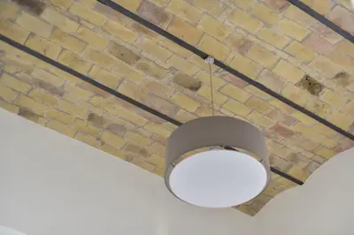 a ceiling light hanging from a brick ceiling at B&B Casa Angelini in Rome