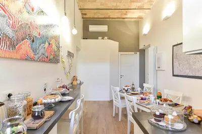 a dining room with tables and chairs with food on them at B&B Casa Angelini in Rome