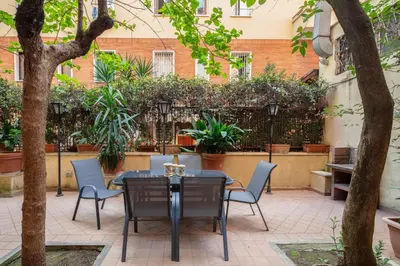 a patio with a table and chairs and plants at B&B Anturium in Rome