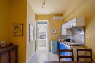 a kitchen with yellow walls and a blue counter top at B&B Anturium in Rome