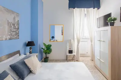 a blue and white bedroom with a bed and a window at B&B Anturium in Rome