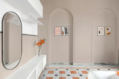 a white room with a mirror and a vase with flowers at BLAM Alice's House, Great view to Santa Maria Maggiore Church in Rome