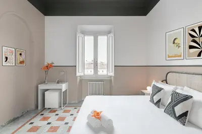 a bedroom with a large white bed with a window at BLAM Alice's House, Great view to Santa Maria Maggiore Church in Rome