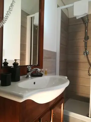a bathroom with a white sink and a shower at Sivory Rome in Rome