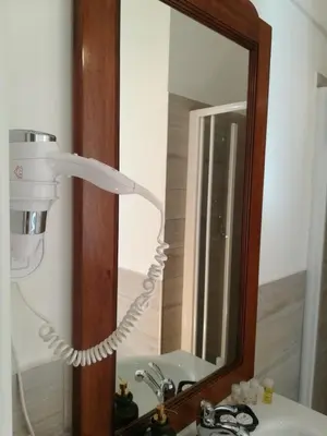 a bathroom with a light on a sink in front of a mirror at Sivory Rome in Rome