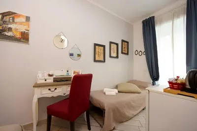a room with a desk and a red chair at Sivory Rome in Rome