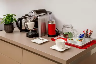 a counter top with a coffee maker and cups at Belli36rooms near Spanish step and Vatican City in Rome