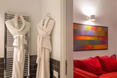 a room with white towels hanging on a wall at Belli36rooms near Spanish step and Vatican City in Rome