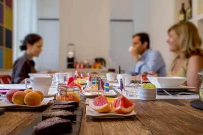 a group of people sitting at a table with food at Belli36rooms near Spanish step and Vatican City in Rome