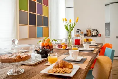 a table with breakfast foods and orange juice on it at Belli36rooms near Spanish step and Vatican City in Rome