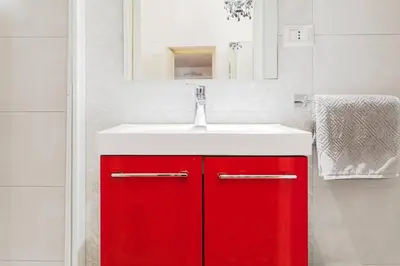 a red cabinet with a sink in a bathroom at World Wide Bed Piazza del Popolo in Rome