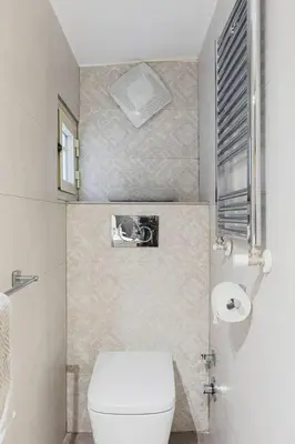 a small bathroom with a toilet and a window at World Wide Bed Piazza del Popolo in Rome