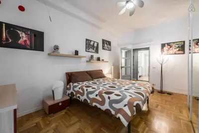 a bedroom with a bed and a ceiling fan at Modern Living San Paolo - Vicino alla Metro in Rome