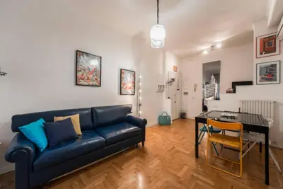 a living room with a blue couch and a table at Modern Living San Paolo - Vicino alla Metro in Rome