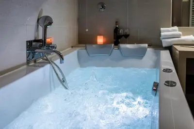 a bath tub filled with water in a bathroom at Navona Central Suites in Rome
