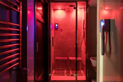 a bathroom with a shower with red lights at Navona Central Suites in Rome