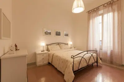 a bedroom with a bed and a window at MamaR Apartment in Rome