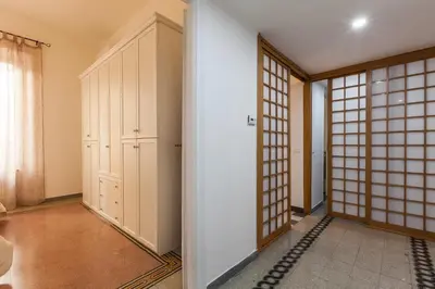 a room with a door and a room with a window at MamaR Apartment in Rome