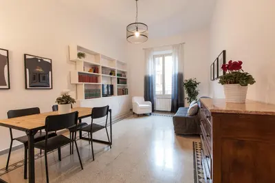 a dining room and living room with a table and chairs at MamaR Apartment in Rome
