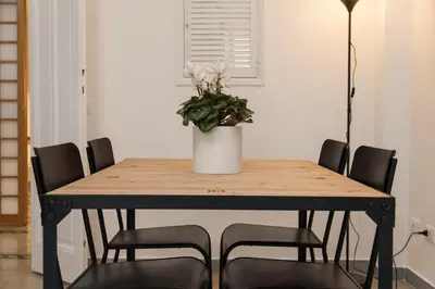 a dining room table with a potted plant on it at MamaR Apartment in Rome