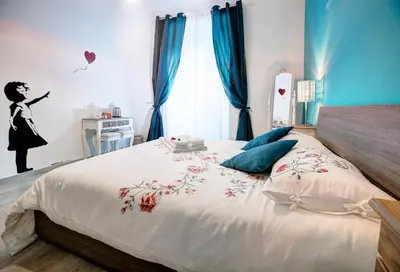 a bedroom with a bed with a woman flying a kite at Viale del Colosseo in Rome