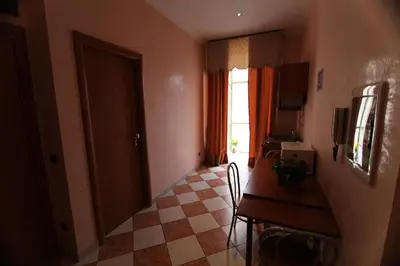 a room with a desk and a table and a window at Elegance in Rome