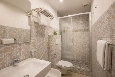 a bathroom with a toilet and a sink and a shower at Amalia Suites by Remember Rome in Rome