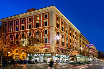 a large building on a city street at night at Amalia Suites by Remember Rome in Rome