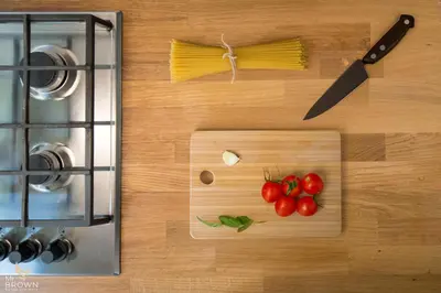 a cutting board with tomatoes and a knife on it at Mr Brown Home and suites in Rome