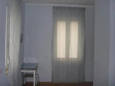 a window in a room with a table and a desk at Sweet Monte Verde in Rome