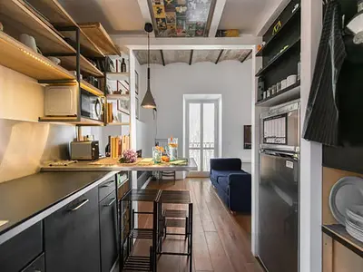 a kitchen with a counter and a dining room at Over The Tiber Loft in Rome