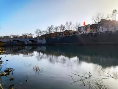 a view of a river with a bridge and buildings at Over The Tiber Loft in Rome