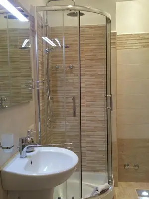 a bathroom with a sink and a glass shower at Mondo Antico in Rome