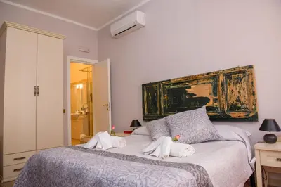 a bedroom with a bed with towels on it at Mondo Antico in Rome