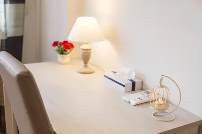 a table with a lamp and a book and a candle at Vatican City Relais in Rome