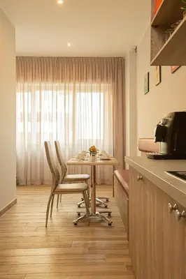 a kitchen with a table and two chairs and a table at Vatican City Relais in Rome
