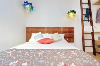 a bedroom with a bed with a ladder at Colosseum Stylish Apartment in Rome