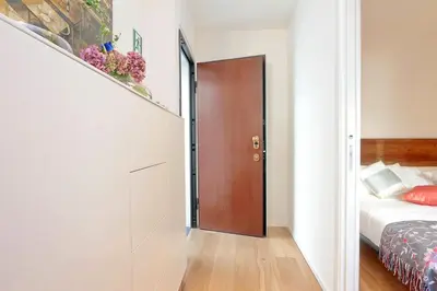 a hallway with a door leading to a bedroom at Colosseum Stylish Apartment in Rome