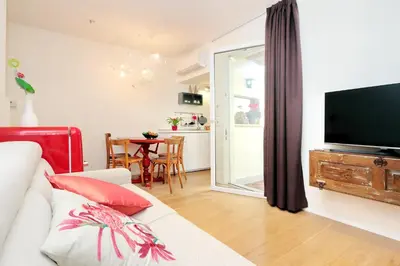 a living room with a couch and a flat screen tv at Colosseum Stylish Apartment in Rome
