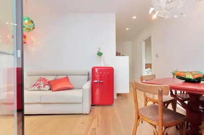 a living room with a couch and a red refrigerator at Colosseum Stylish Apartment in Rome