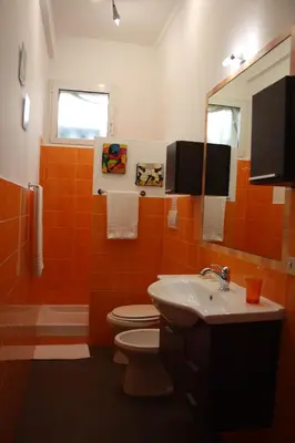 a bathroom with a toilet and a sink and a mirror at Marziah Inn in Rome