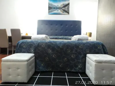 a bedroom with a blue bed with two stools at Marziah Inn in Rome