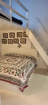 a bed in a room with a staircase at Pantheon Domus Valentino in Rome