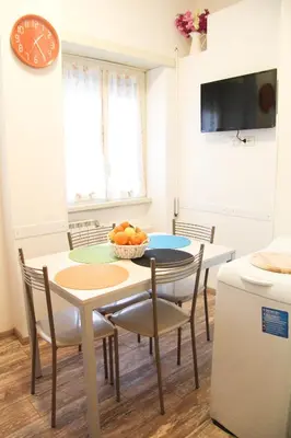 a kitchen and dining room with a table and chairs at Maison Velia in Rome
